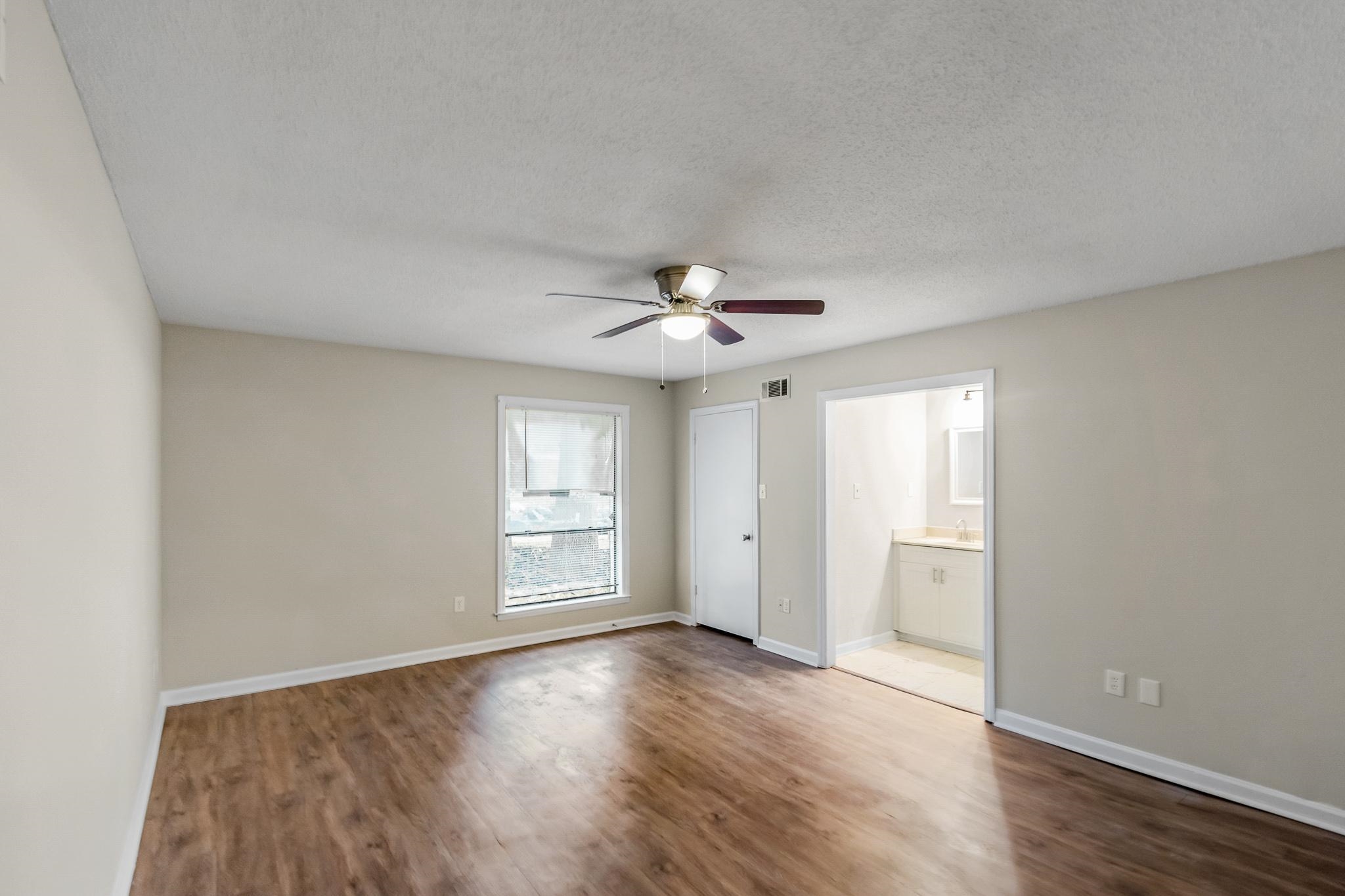 3036 Canyon Road Memphis, TN 38134 - Photo 17 of 24 an empty room with wooden floor fan and windows