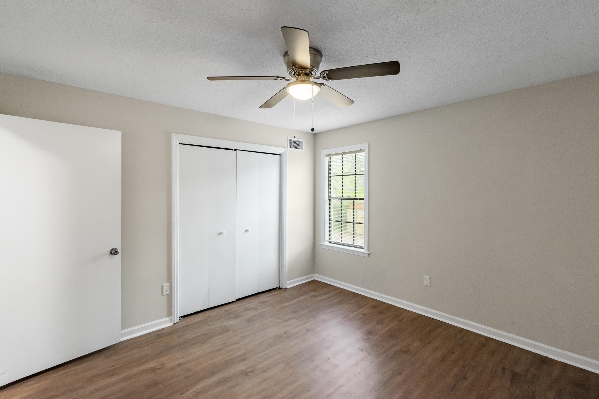 3036 Canyon Road Memphis, TN 38134 - Photo 23 of 24 a view of an empty room with wooden floor and a window