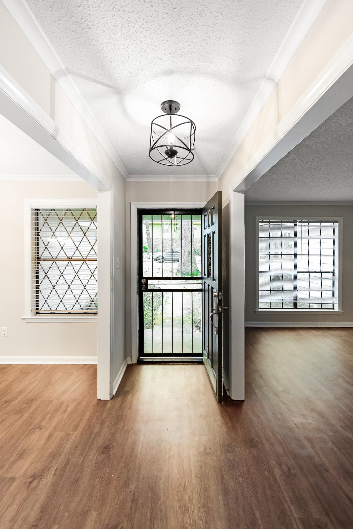 3036 Canyon Road Memphis, TN 38134 - Photo 5 of 24 an empty room with wooden floor and windows