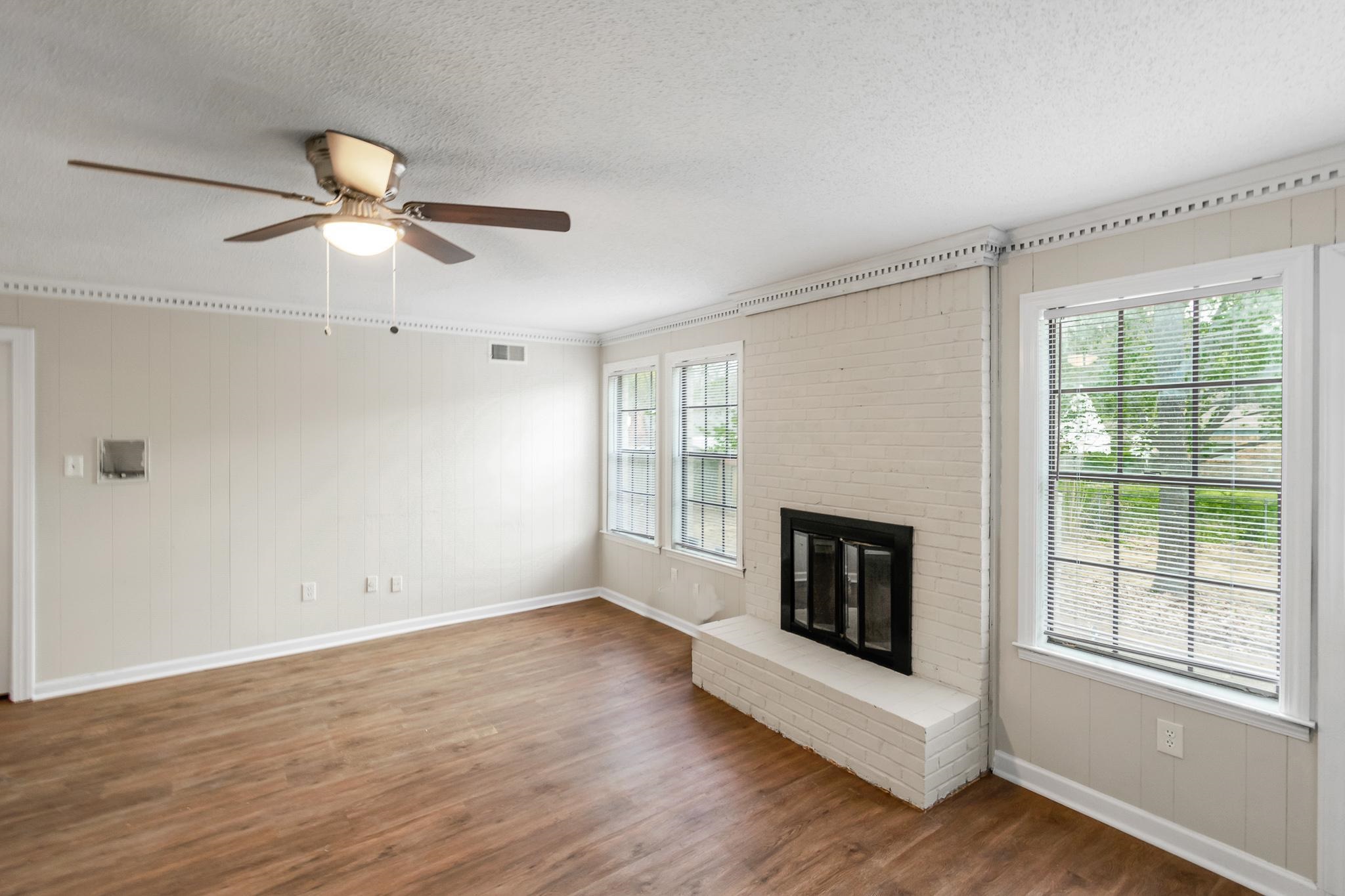 3036 Canyon Road Memphis, TN 38134 - Photo 6 of 24 a view of wooden floor fire place and windows in a room