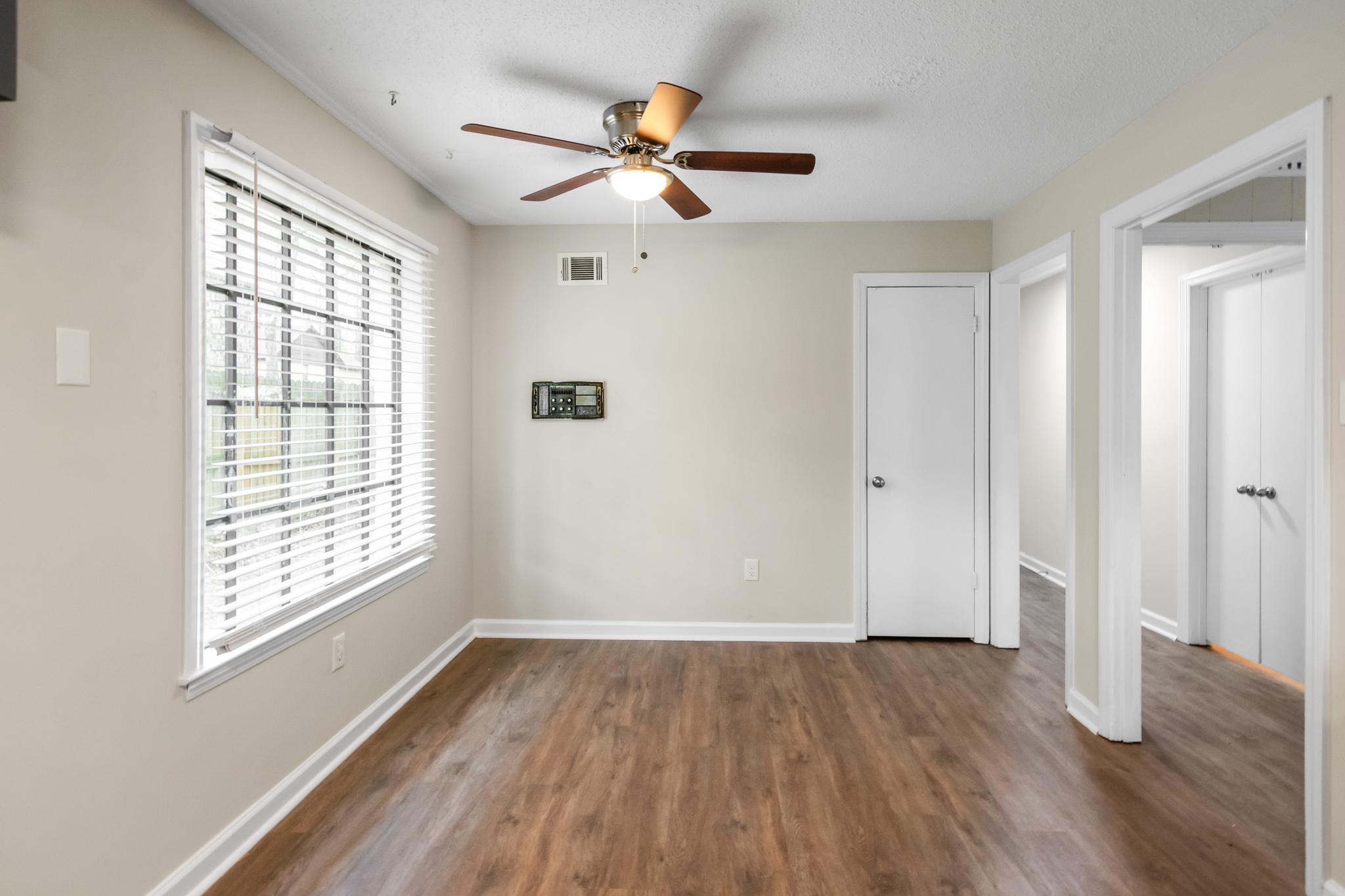 3036 Canyon Road Memphis, TN 38134 - Photo 8 of 24 a view of empty room with wooden floor and fan