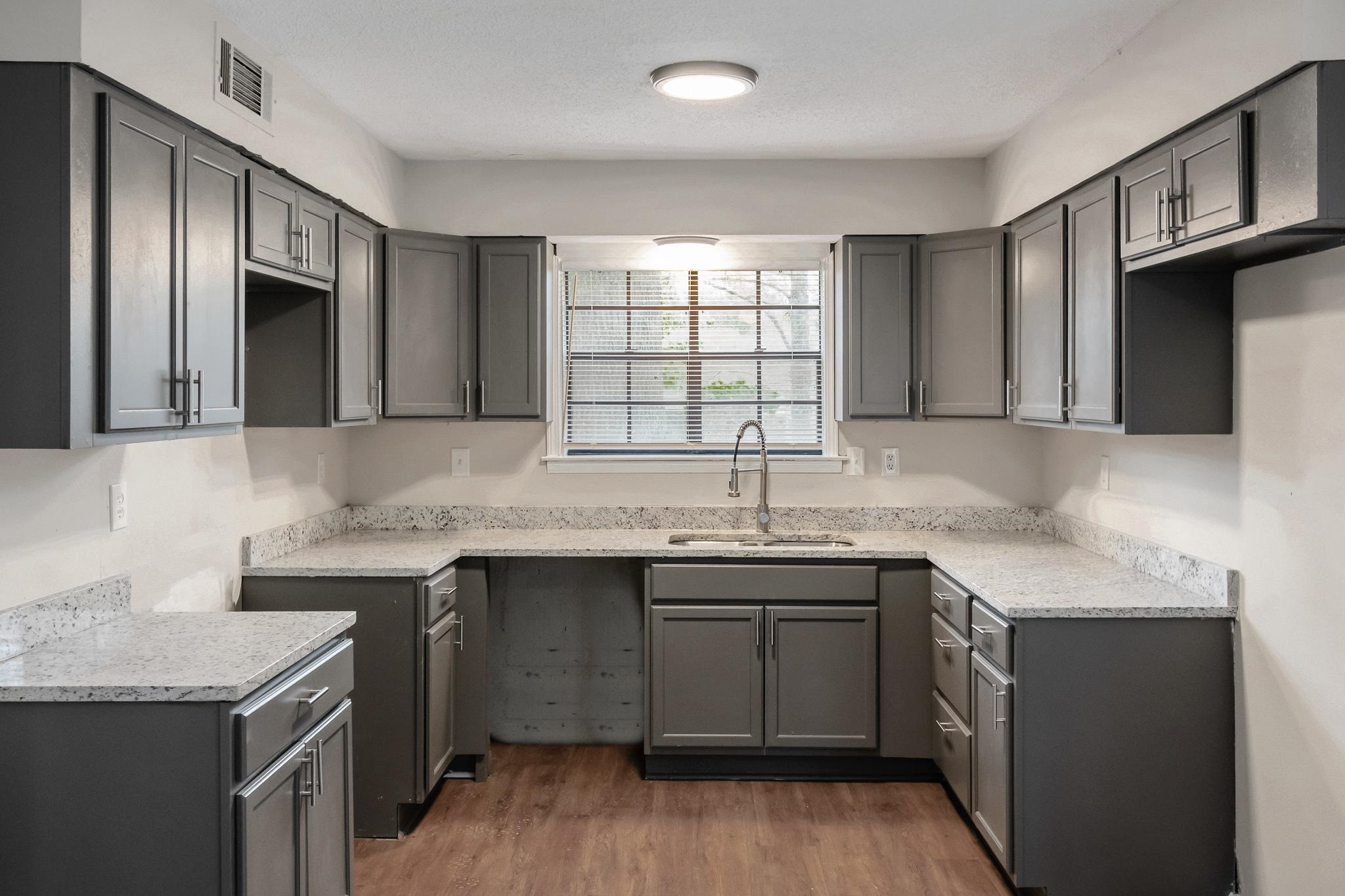 3036 Canyon Road Memphis, TN 38134 - Photo 9 of 24 a kitchen with a sink stove and cabinets