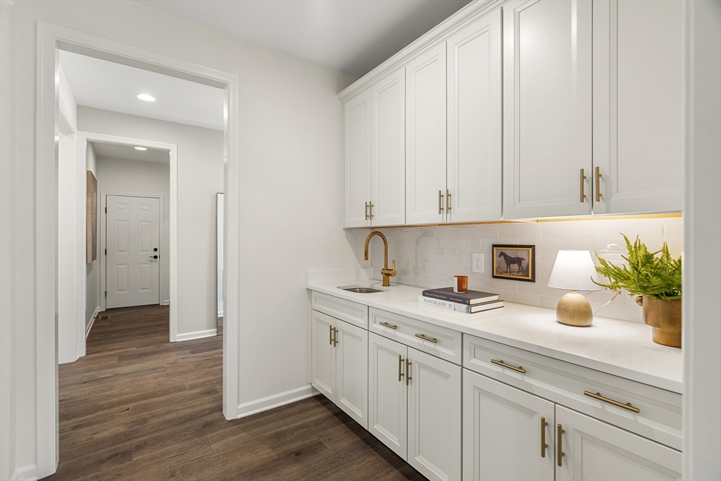29 Germain Way, Unit 3 Norton, MA 02766 - Photo 11 of 40 a view of a kitchen with a sink and dishwasher with wooden floor