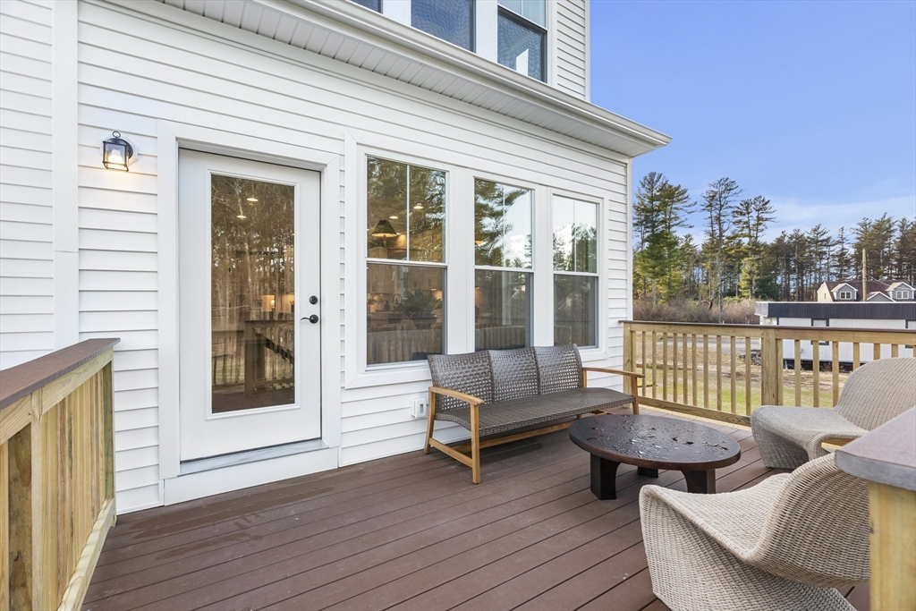 29 Germain Way, Unit 3 Norton, MA 02766 - Photo 40 of 40 a balcony with furniture and wooden floor