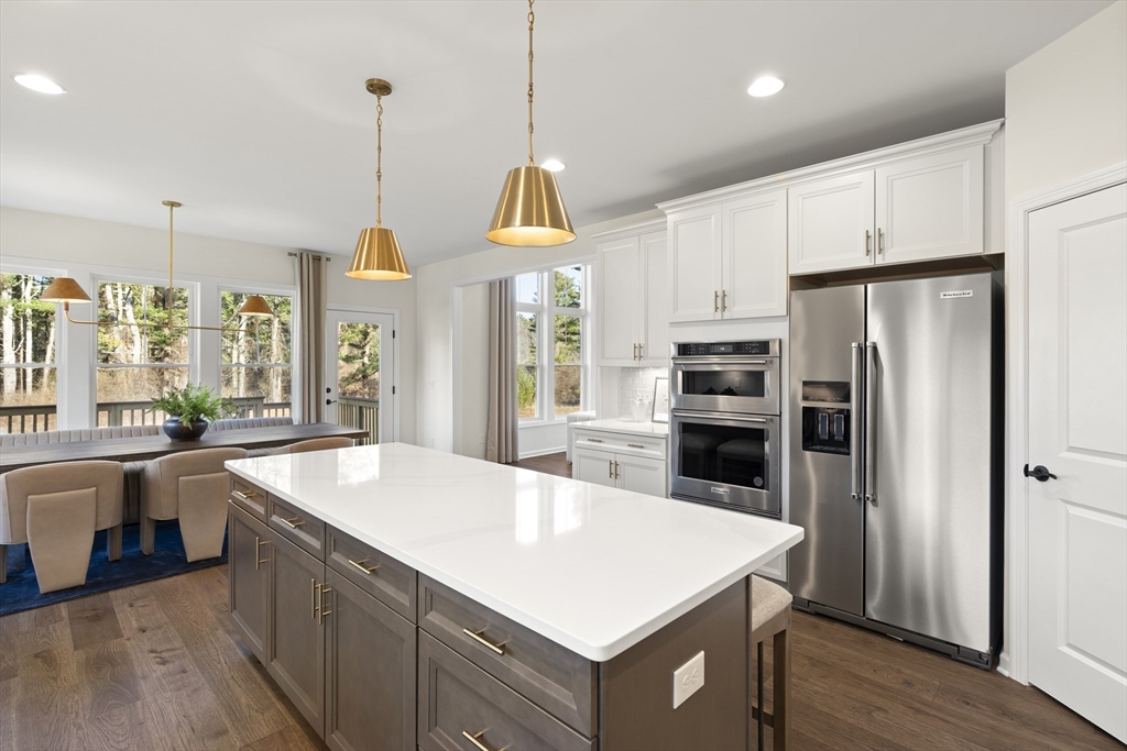 29 Germain Way, Unit 3 Norton, MA 02766 - Photo 8 of 40 a kitchen with stainless steel appliances granite countertop a refrigerator a sink a stove and a wooden floors