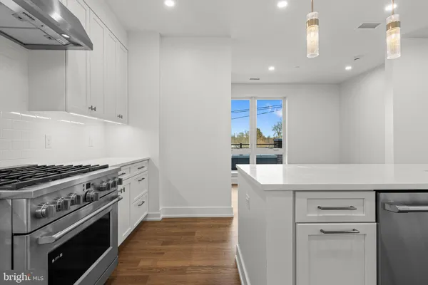a kitchen with a stove and a refrigerator