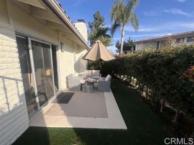7061 Estrella De Mar Road, Unit 66 Carlsbad, CA 92009 - Photo 15 of 17 a view of a house with backyard porch and sitting area