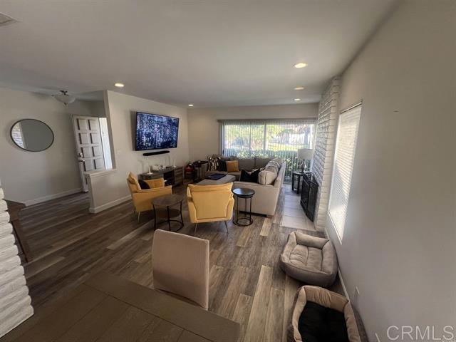 7061 Estrella De Mar Road, Unit 66 Carlsbad, CA 92009 - Photo 2 of 17 a living room with furniture and a flat screen tv