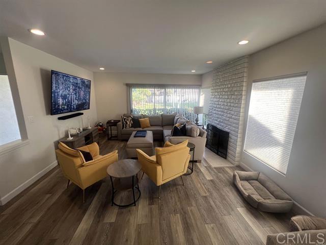 7061 Estrella De Mar Road, Unit 66 Carlsbad, CA 92009 - Photo 3 of 17 a living room with furniture and wooden floor