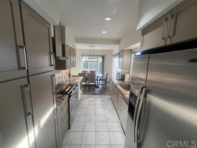 7061 Estrella De Mar Road, Unit 66 Carlsbad, CA 92009 - Photo 4 of 17 a kitchen with stainless steel appliances granite countertop a refrigerator and a stove