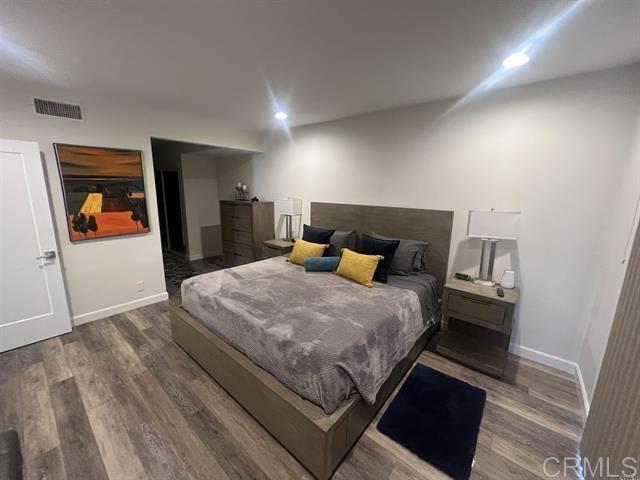 7061 Estrella De Mar Road, Unit 66 Carlsbad, CA 92009 - Photo 5 of 17 a bedroom with a bed and wooden floor