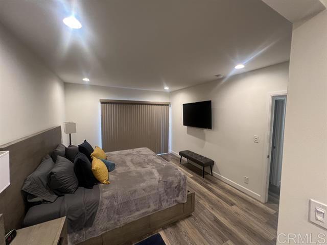 7061 Estrella De Mar Road, Unit 66 Carlsbad, CA 92009 - Photo 6 of 17 a bedroom with a bed and a flat screen tv