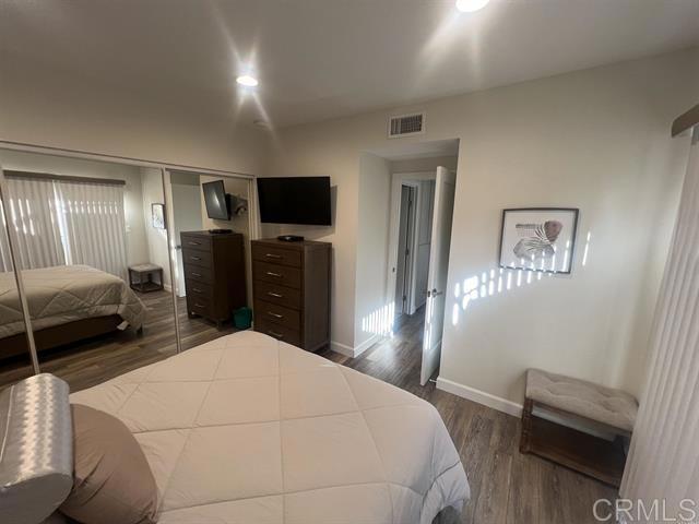 7061 Estrella De Mar Road, Unit 66 Carlsbad, CA 92009 - Photo 7 of 17 a bedroom with a bed and a flat screen tv