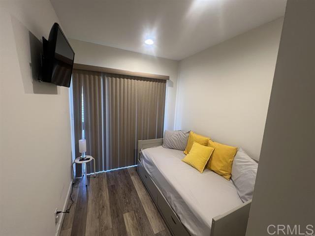 7061 Estrella De Mar Road, Unit 66 Carlsbad, CA 92009 - Photo 9 of 17 a bedroom with a bed and flat screen tv