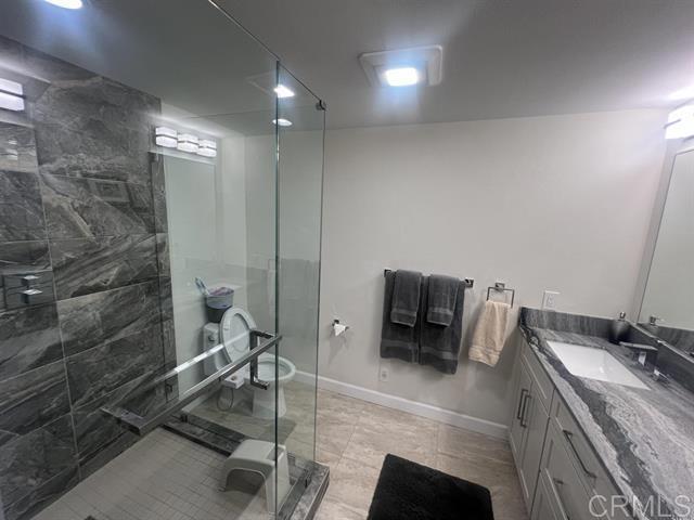 7061 Estrella De Mar Road, Unit 66 Carlsbad, CA 92009 - Photo 10 of 17 a bathroom with a sink and a mirror