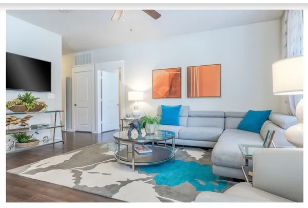 a living room with furniture and a flat screen tv