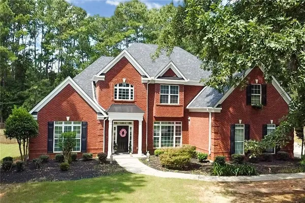 a front view of a house with a yard