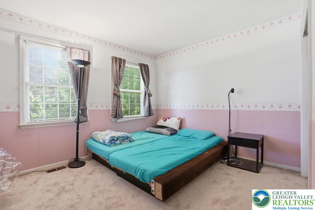 808 Hunter Road Easton, PA 18040 - Photo 21 of 41 Two large windows naturally illuminate this cozy bedroom with soft carpeting.
