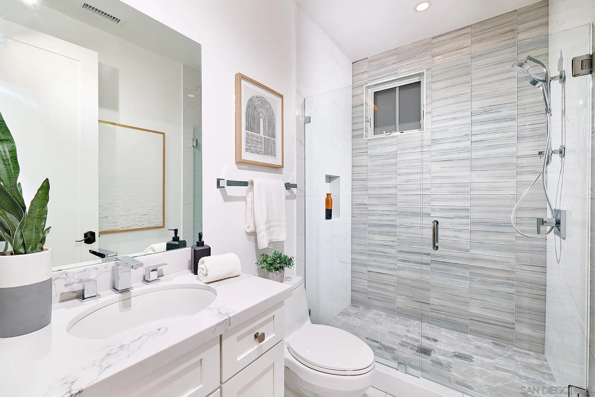 12410 Aria Court Poway, CA 92064 - Photo 16 of 47 a bathroom with a sink a toilet a glass door shower and a mirror