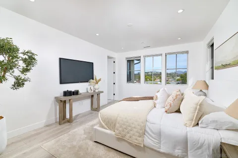 a bedroom with a flat screen tv and a bed