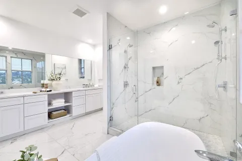 a bathroom with a sink a toilet and shower