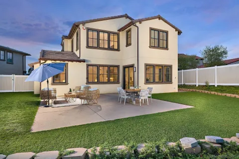 a view of a house with a yard and sitting area