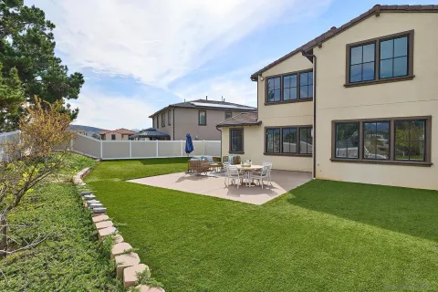 a view of a house with backyard and sitting area