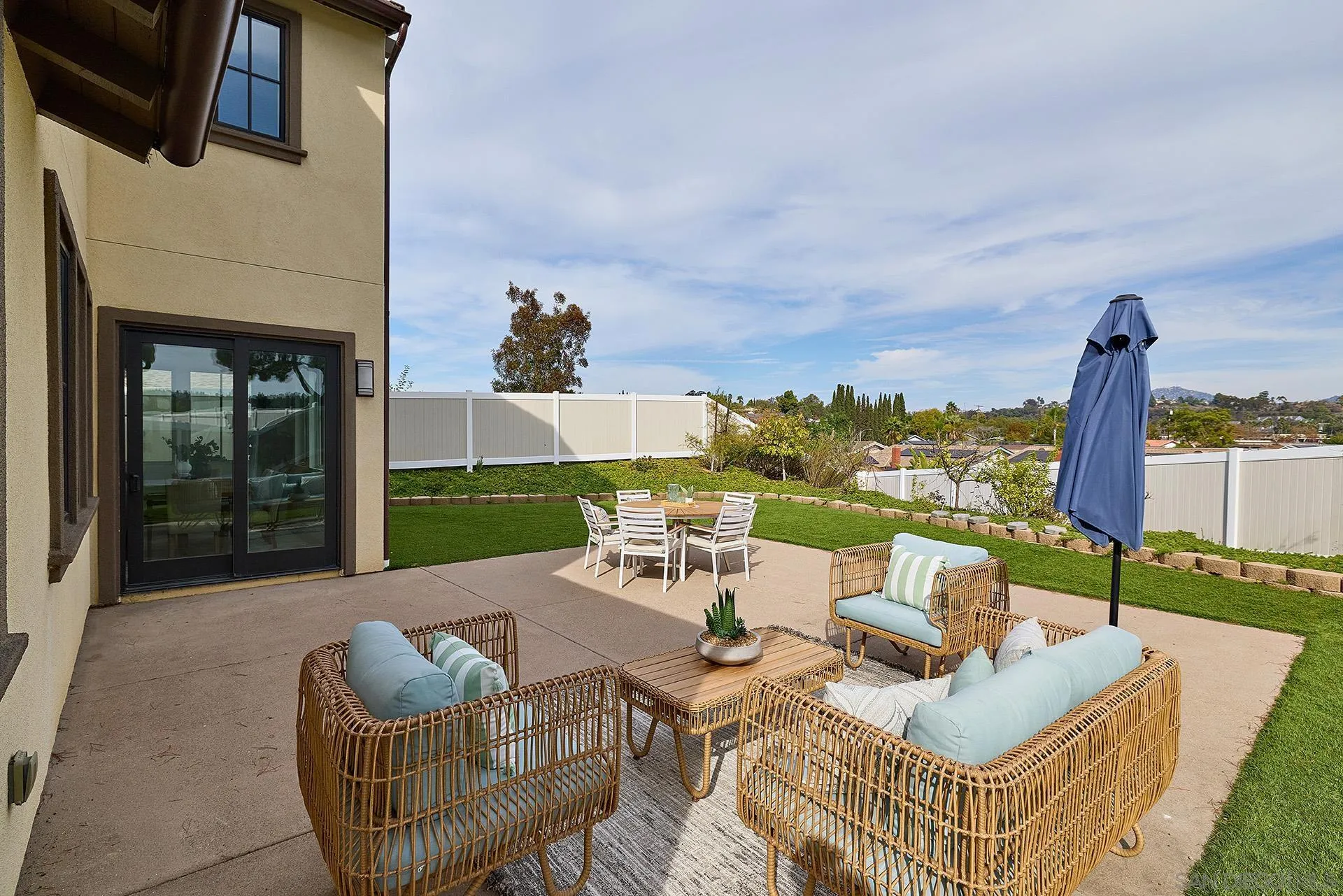 12410 Aria Court Poway, CA 92064 - Photo 37 of 47 a view of a patio with couches chairs and a floor to ceiling window