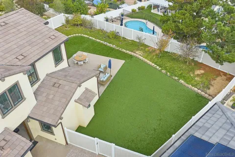 a view of a wooden deck and a backyard