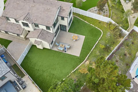 a green field with some trees in the background