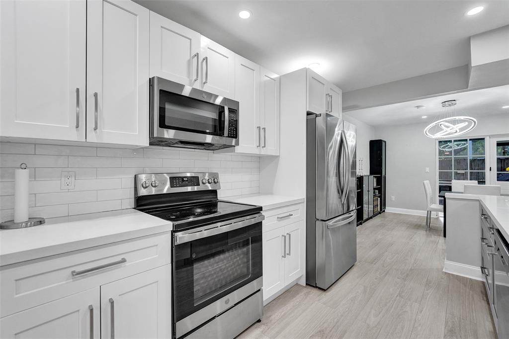 3301 Raleigh Street, Unit 4B Hollywood, FL 33021 - Photo 11 of 54 a kitchen with granite countertop a refrigerator stove and microwave