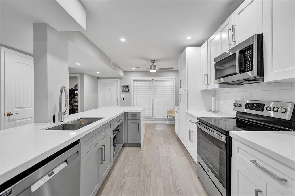 3301 Raleigh Street, Unit 4B Hollywood, FL 33021 - Photo 13 of 54 a large kitchen with stainless steel appliances granite countertop a lot of counter space and wooden floor