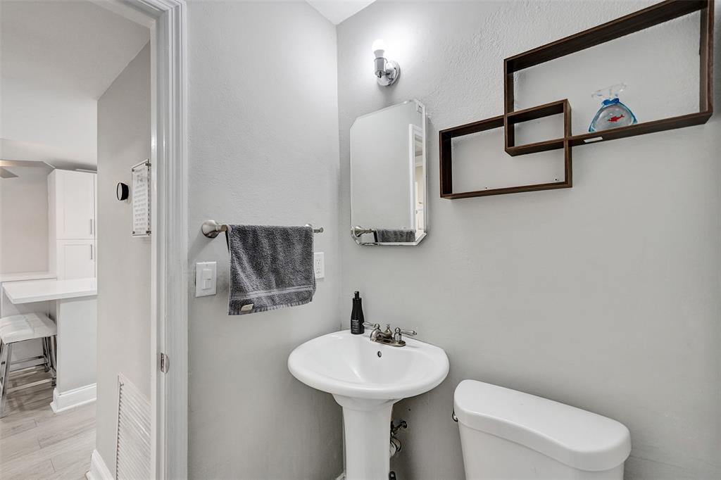 3301 Raleigh Street, Unit 4B Hollywood, FL 33021 - Photo 24 of 54 a bathroom with a sink a toilet and mirror