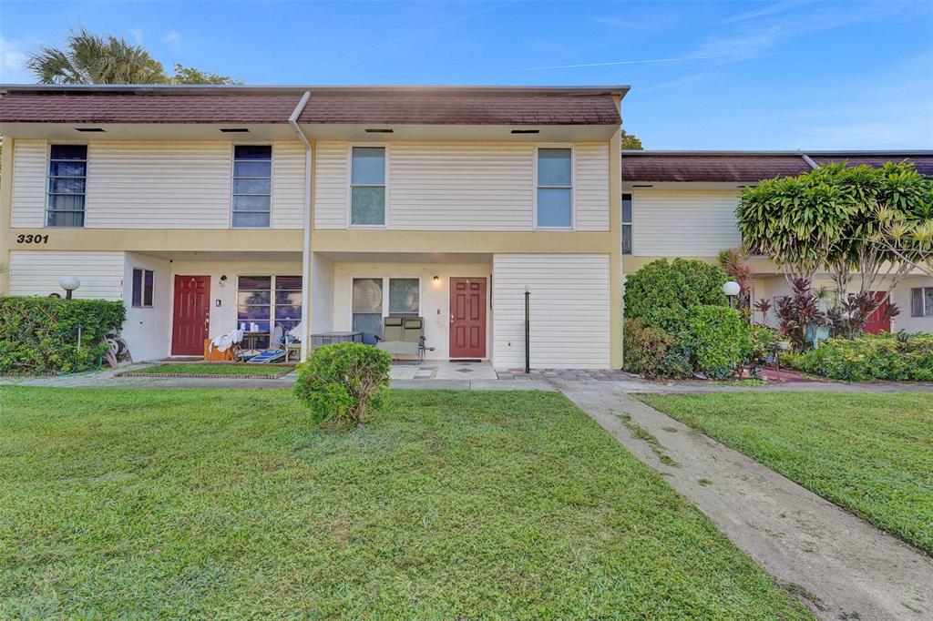 3301 Raleigh Street, Unit 4B Hollywood, FL 33021 - Photo 3 of 54 front view of a house with a yard