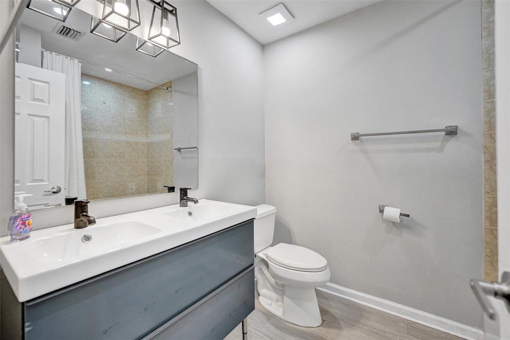3301 Raleigh Street, Unit 4B Hollywood, FL 33021 - Photo 33 of 54 a bathroom with a sink mirror and toilet