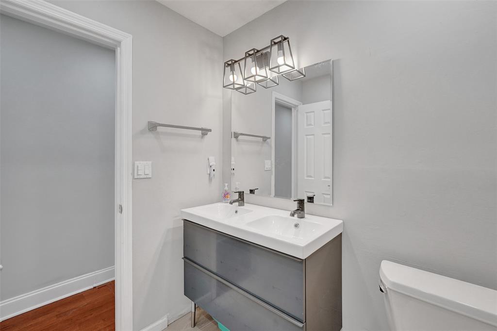 3301 Raleigh Street, Unit 4B Hollywood, FL 33021 - Photo 34 of 54 a bathroom with a sink a toilet and a mirror