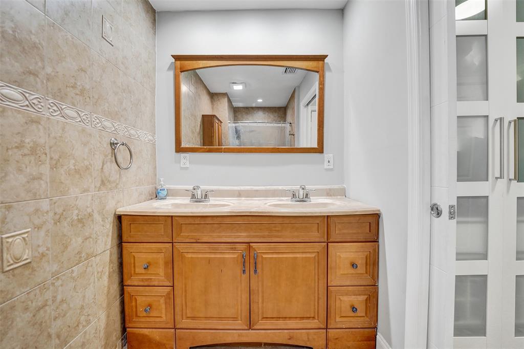 3301 Raleigh Street, Unit 4B Hollywood, FL 33021 - Photo 48 of 54 a bathroom with a sink and a mirror