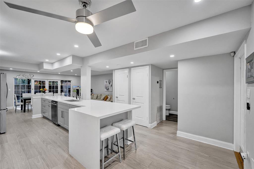 3301 Raleigh Street, Unit 4B Hollywood, FL 33021 - Photo 9 of 54 a large kitchen with kitchen island a large island a sink stainless steel appliances and cabinets