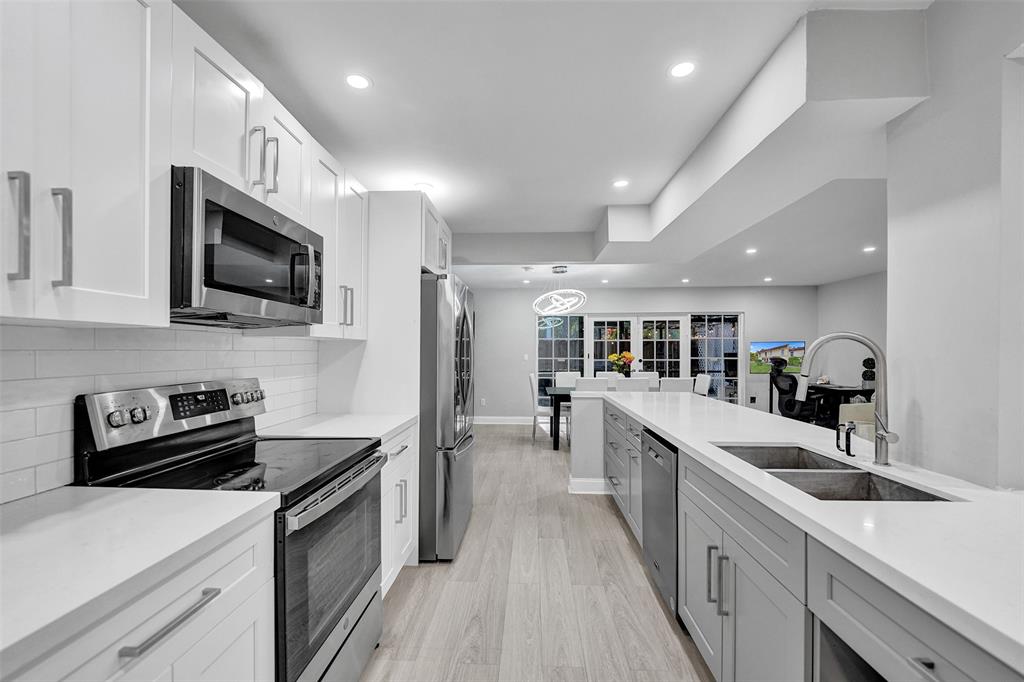 3301 Raleigh Street, Unit 4B Hollywood, FL 33021 - Photo 10 of 54 a kitchen with counter top space stainless steel appliances and cabinets