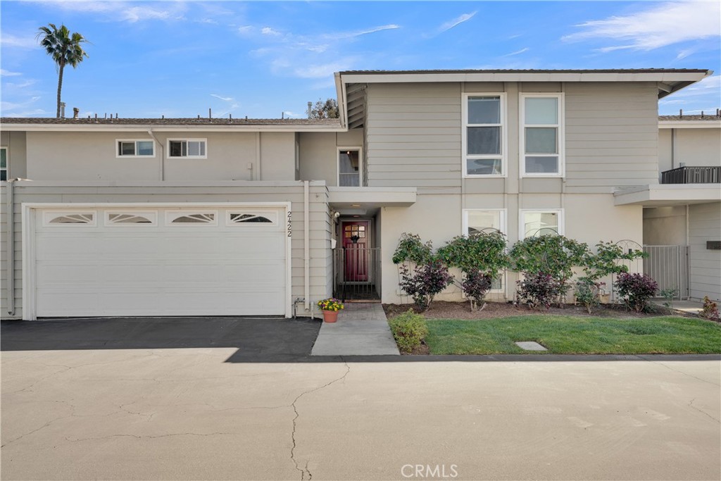 2422 Miseno Way Costa Mesa, CA 92627 - Photo 1 of 40 a front view of a house with a yard and garage