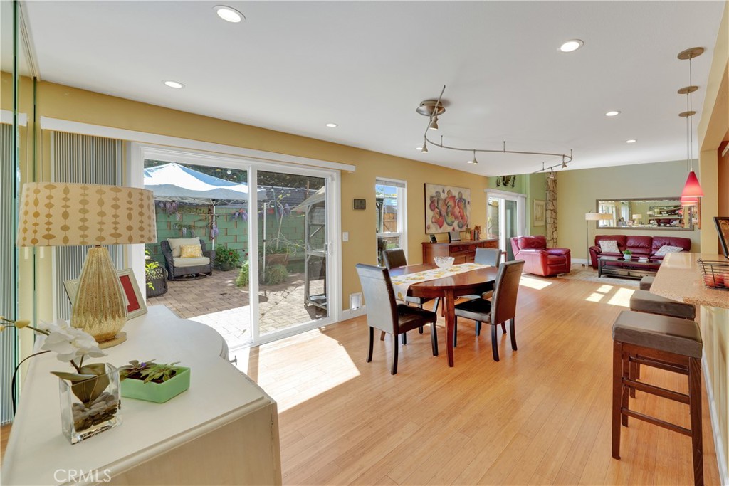 2422 Miseno Way Costa Mesa, CA 92627 - Photo 12 of 40 a view of a dining room with furniture and wooden floor