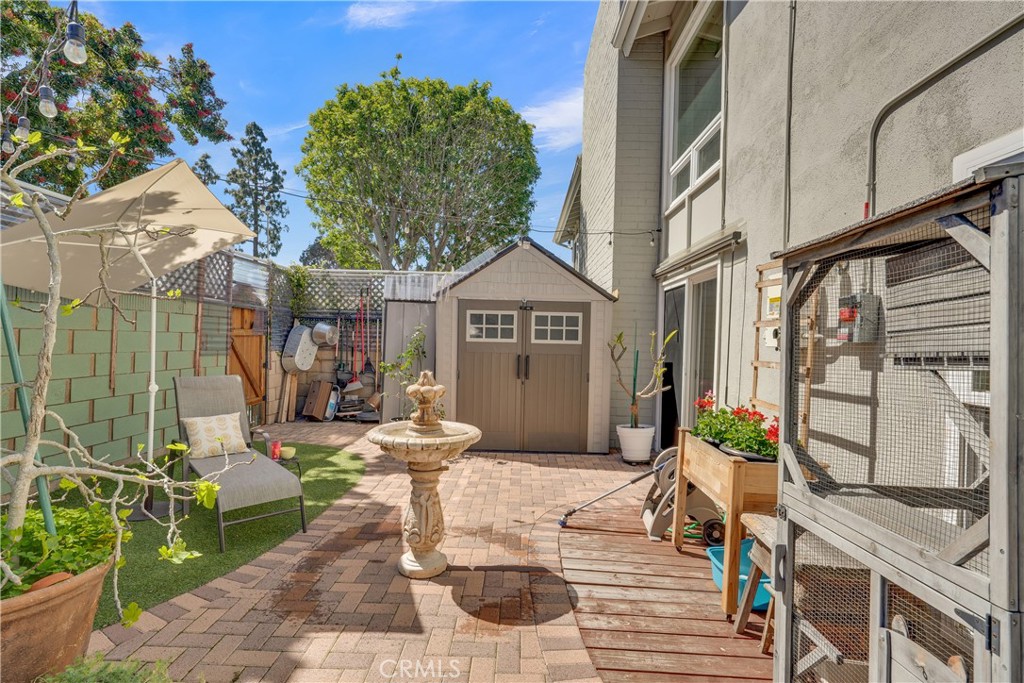 2422 Miseno Way Costa Mesa, CA 92627 - Photo 20 of 40 a view of a patio with table and chairs and potted plants