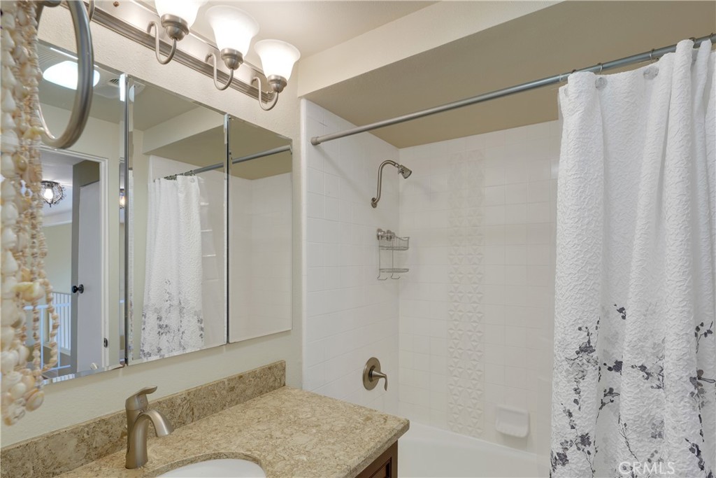 2422 Miseno Way Costa Mesa, CA 92627 - Photo 27 of 40 a bathroom with a granite countertop bathtub shower and a sink