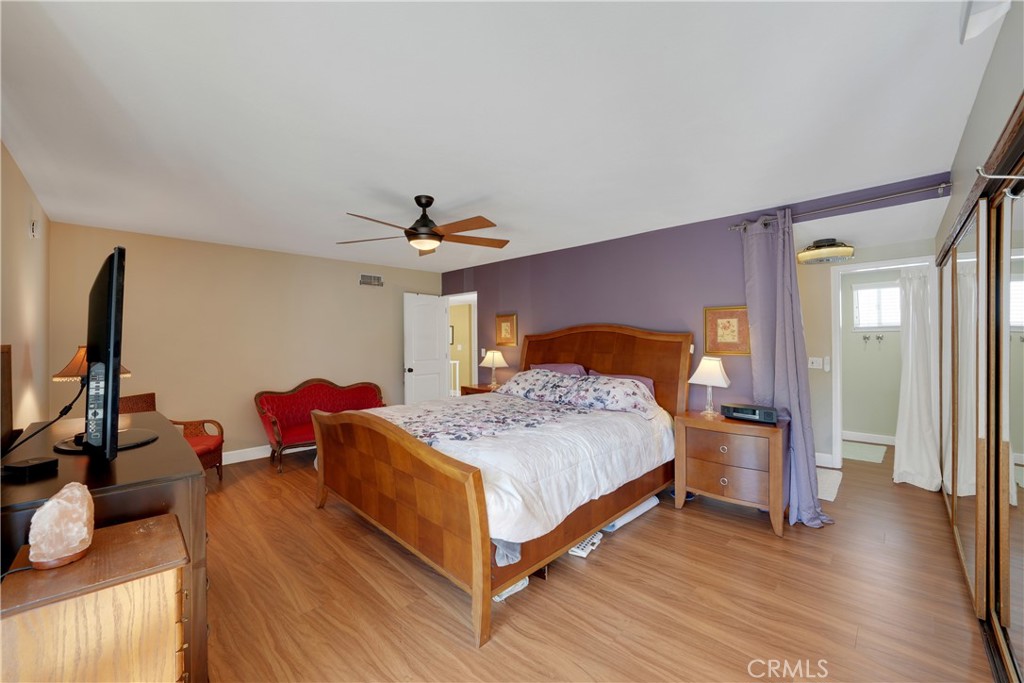 2422 Miseno Way Costa Mesa, CA 92627 - Photo 29 of 40 a bedroom with a bed and wooden floor