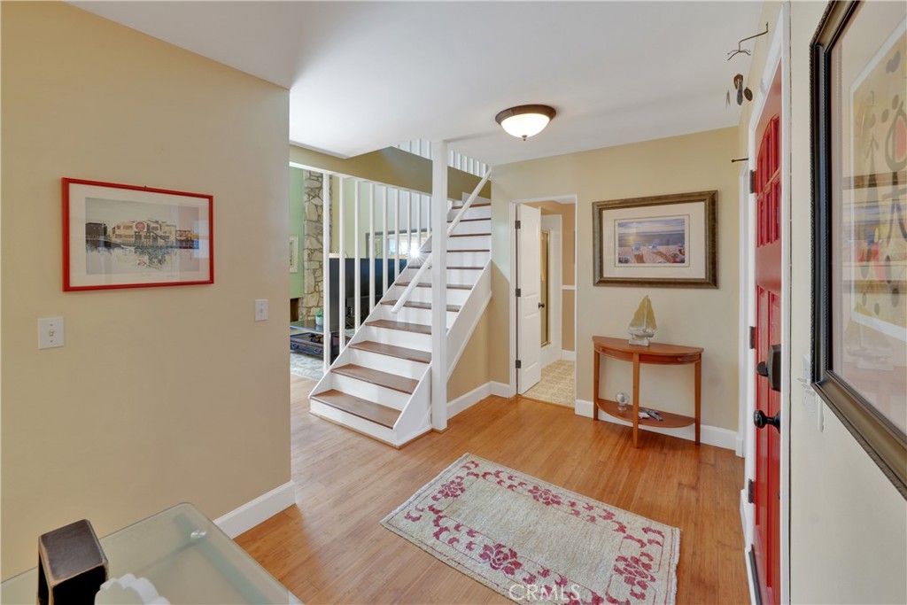 2422 Miseno Way Costa Mesa, CA 92627 - Photo 4 of 40 a view of a hallway with workspace and stairs