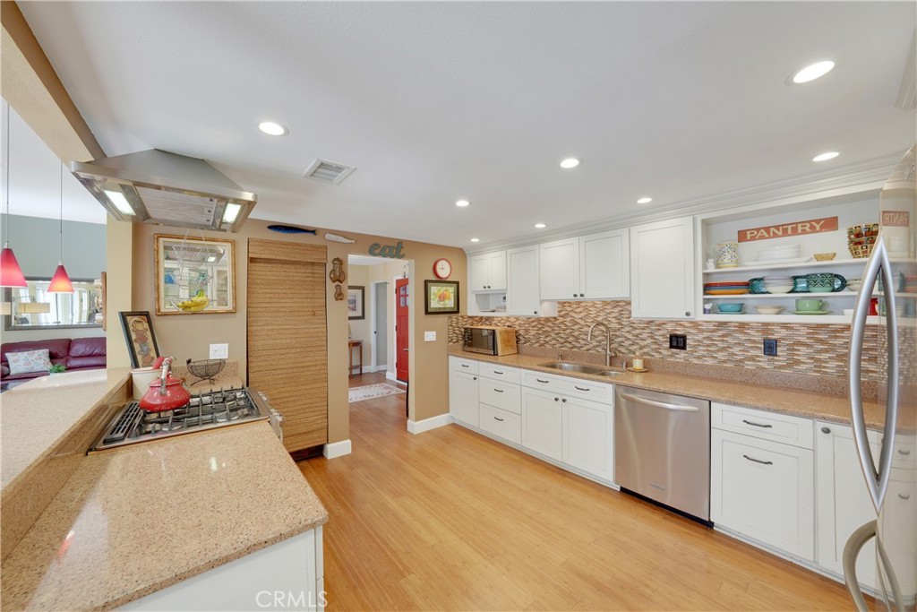 2422 Miseno Way Costa Mesa, CA 92627 - Photo 9 of 40 a kitchen with refrigerator and sink