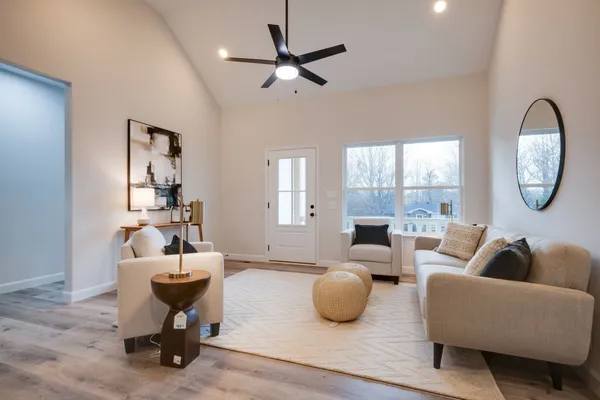 a living room with furniture a rug and a large window