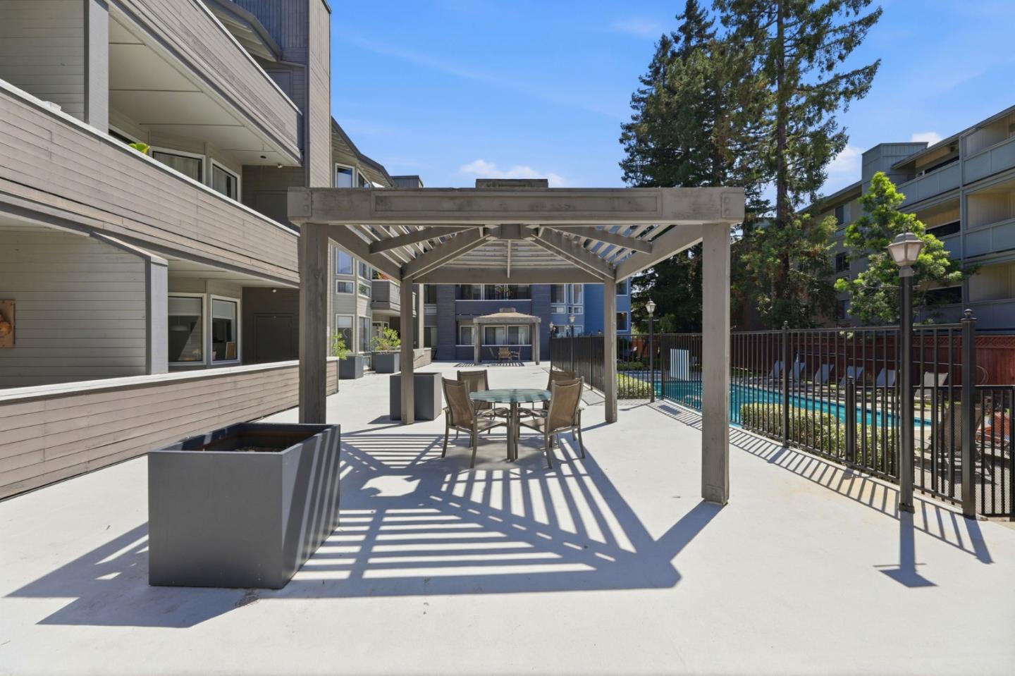 22330 Homestead Road, Unit 226 Cupertino, CA 95014 - Photo 36 of 38 a view of a patio with couches table and chairs and potted plants