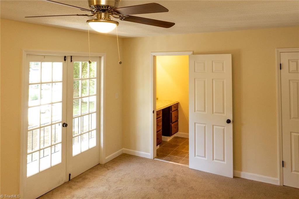 2824 Montclair Road Winston-Salem, NC 27106 - Photo 17 of 30 Main level master bedroom with access to private balcony. Also, features a private powder room leading to bathroom!