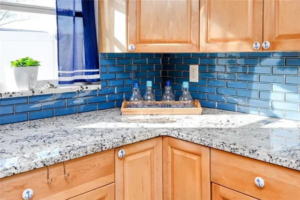 a kitchen with granite countertop sink and cabinets